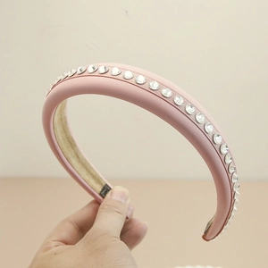 Pink leather padded headband with sparkling rhinestones for a vintage hair accessory look