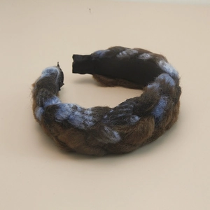 Detailed weave of thick brown and blue wool knit headband for autumn and winter