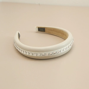 Detail of cream leather headband featuring sparkling rhinestones and thick sponge design