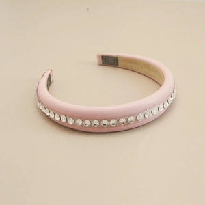 Close-up of pink leather headband with sparkling rhinestone inlay and non-slip inner lining