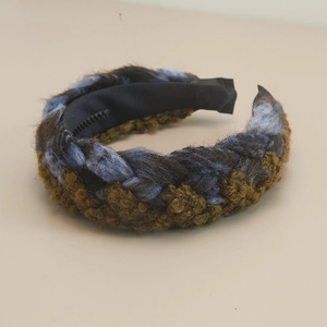 Close-up of thick bohemian braided headband with blue and brown yarn texture
