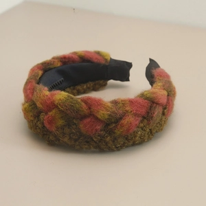 Close-up of bohemian pink and green woven headband with twisted knit texture and inner lining