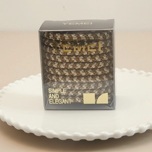 Close-up of elastic woven hair ties in a simple transparent elegant brand box on a tray