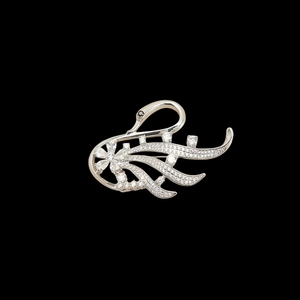 Macro shot of silver-tone swan brooch showing detailed white zircon pavé setting