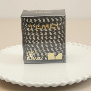 Detail of checkered high-elasticity hair scrunchies in elegant transparent display box