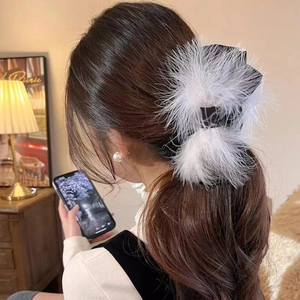 Elegant large hair claw clip featuring white ostrich feathers and a black satin bow