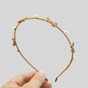 Brown flocked headband with white pearls and small bows for high skull top hairstyle