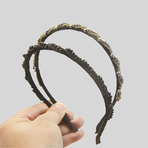 Detail of twisted bead headbands with gunmetal finish and shimmering crystals