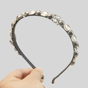 Elegant vintage headband with grey faux pearls and crystal accents on slim black band