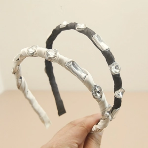 Detailed view of handmade baroque headband with satin fabric and clear crystals