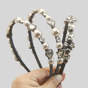 Detail shot of three elegant slim headbands featuring pearls, rhinestones and metal beads