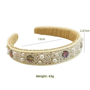 Detailed view of handmade baroque headband with pearls and crystals on woven fabric