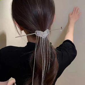 Detail view of heart rhinestone tassel hair pin on model's hair with silver chains