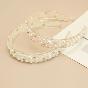Detail of handmade baroque headbands with ivory and pink pearls and sparkling rhinestones