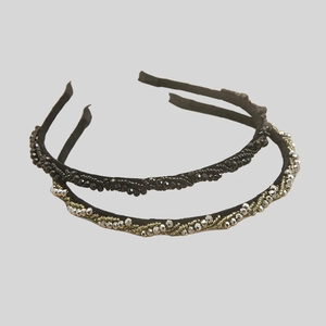 Detailed view of hand-beaded headbands featuring black faceted beads and metallic accents