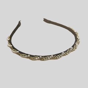 Detail of twisted headband with metallic beads and sparkling interwoven texture