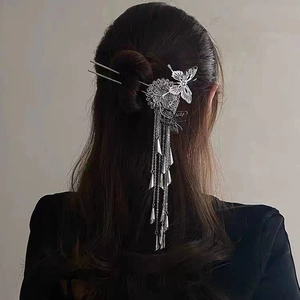 Silver butterfly hair pin with tassels on hair bun showing vintage Chinese style
