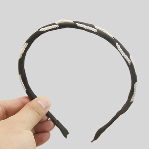 Elegant black fabric headband with faux pearl embellishments and a minimalist vintage design