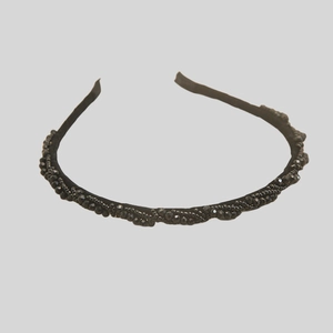 Close-up of black beaded woven headband featuring intricate handcrafted texture and detail