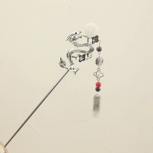 Close-up of silver dragon hair pin with hanging red and black beads for Hanfu styling