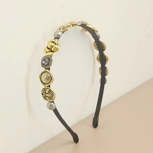 Detail of vintage Baroque headband with embossed gold buttons and grey pearls