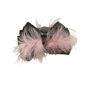 Pink ostrich feather hair claw clip with a black satin bow for women in a luxury design