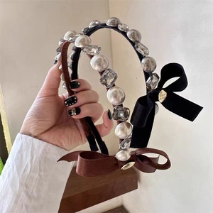 Detailed macro view of French style headbands with silk bows, pearls and crystals