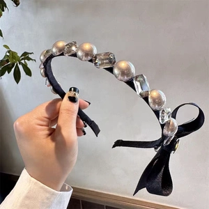 Elegant headband with faux pearls, rhinestones and a black side bow for women