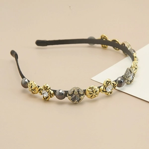Detail of baroque headband featuring vintage gold carvings, pearls, and crystals
