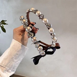 Elegant headband with large pearls, clear crystals and side ribbon bows for women