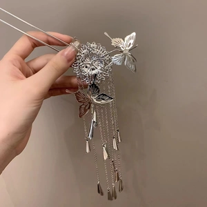 Detail view of silver butterfly hairpin with tassels and S925 engraved stamp