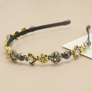 Close-up of Baroque headband with vintage gold crosses and embedded pearls and crystals