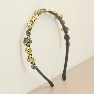 Macro detail of Baroque style headband with pearls, crystals and gold cross ornaments