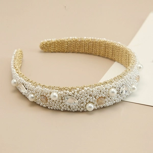 Close-up of luxury Baroque headband with white pearls and champagne crystal details