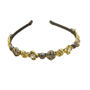 Vintage Baroque headband with pearls and rhinestones on black frame over white background
