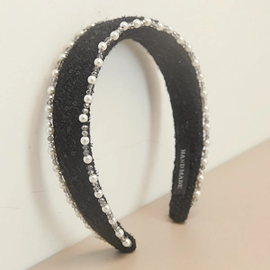 Detailed close-up of French vintage black tweed headband with white pearls and grey crystal beads