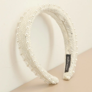 Close-up of handmade white tweed headband with elegant pearls and silver sequins