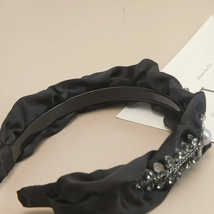 Luxurious black pleated satin headband with rhinestone leaves and white pearl accents
