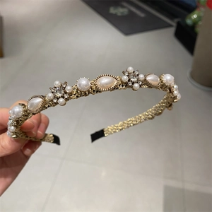 Elegant vintage gold headband with faux pearls and rhinestones in a floral arrangement