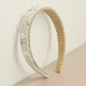 Detailed close-up of Baroque headband with ivory pearls and shimmering rhinestones