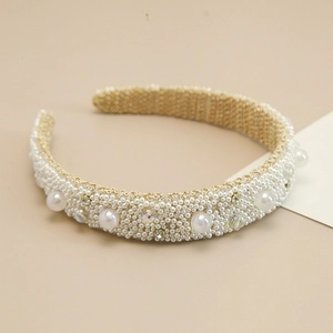Detail of handmade baroque headband with white pearls and sparkling rhinestones