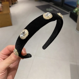 Close-up of black velvet headband featuring four large oval rhinestones in vintage style