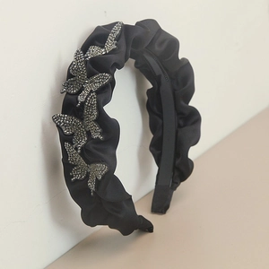 Detail of pleated black satin headband with sparkling silver rhinestone butterflies