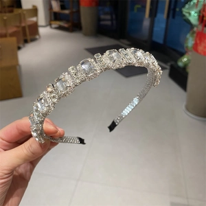 Detail view of silver sparkling rhinestone leaf headband with crystal accents