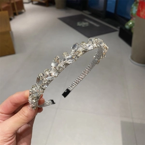 Sparkling crystal leaf headband with silver metal base and geometric rhinestone details