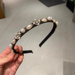 Close-up of elegant French style headband with white pearls and sparkling crystal flowers