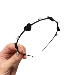 Elegant black velvet headband with red heart accents and white pearls for women