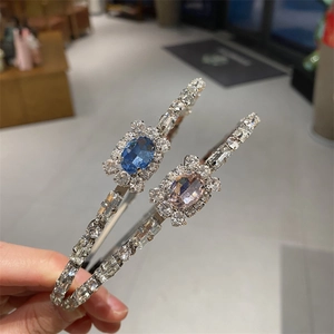 Elegant rhinestone headband set with large blue and pink crystals on silver metal band