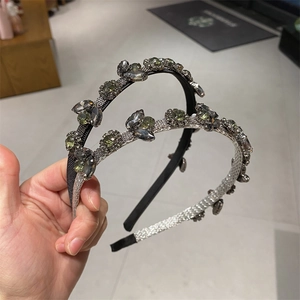 Detail of two-piece sparkling rhinestone leaf headbands with woven texture base