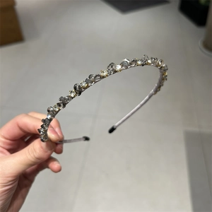 Close-up of handmade gray beaded crystal headband on a slim lavender metal frame
